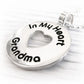 Silver pendant with 'In My Heart Grandma' engraving on a white background