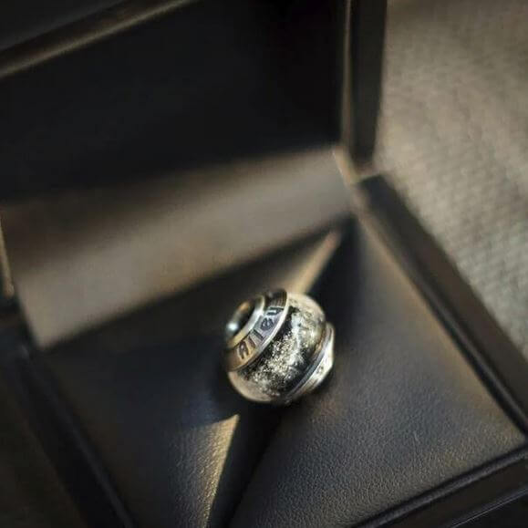 Silver glass cremation ash memorial bead in a black jewelry box