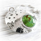 Cremation ashes in green hand blown glass on a pet memorial necklace