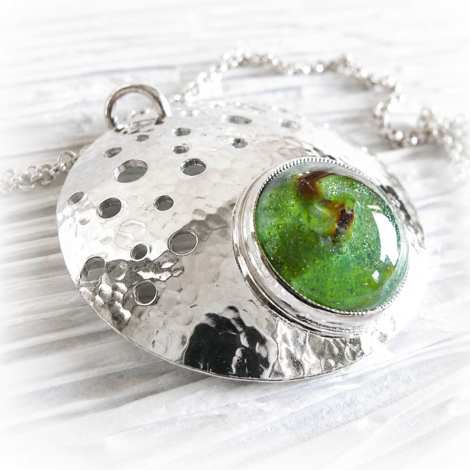 Cremation ashes in green hand blown glass on a pet memorial necklace