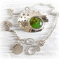 Sterling silver memorial necklace with cremation ashes permanently encased in green glass