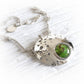 Hand forged sterling silver memorial necklace featuring glass containing cremation ashed 