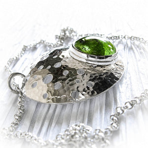 Hand blown glass infused with cremation ashes set on a sterling silver pendant