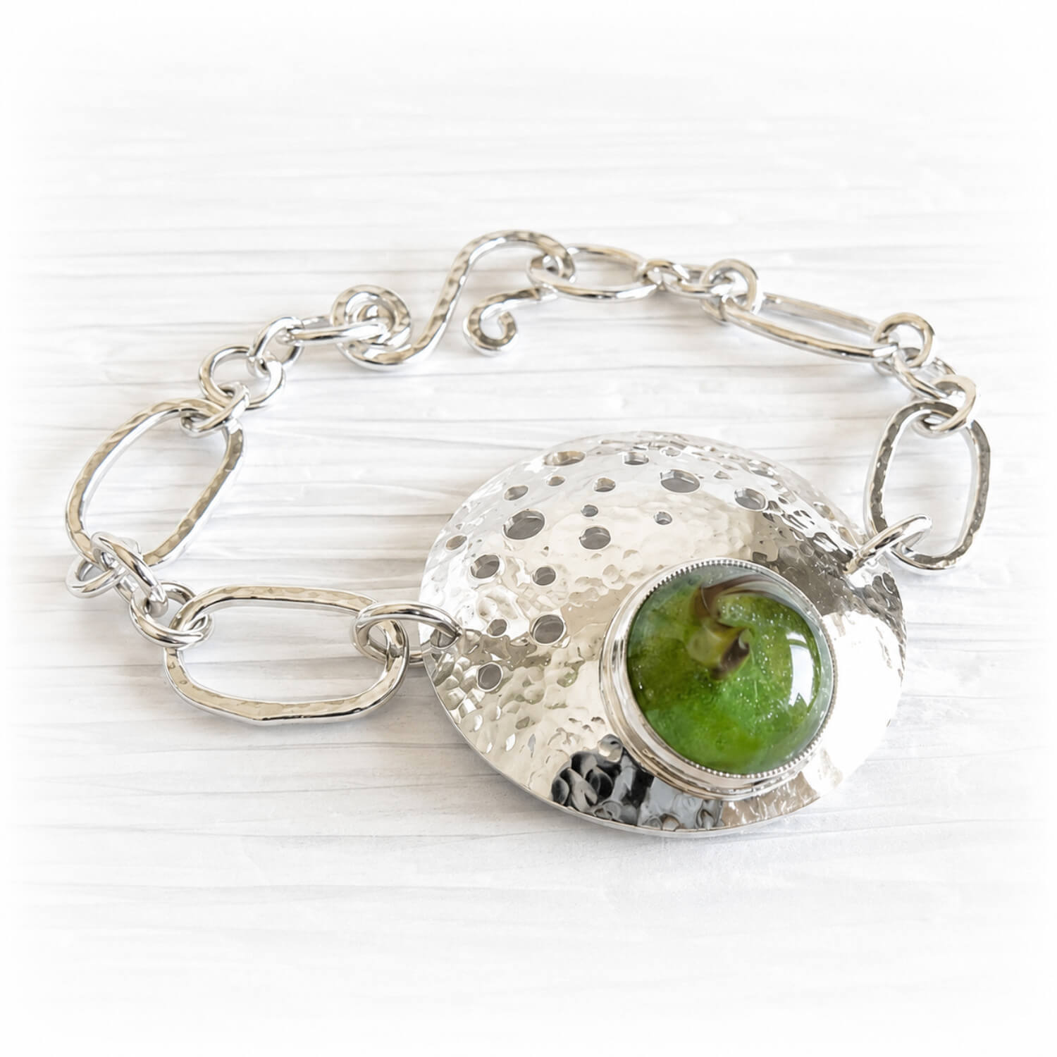 Handcrafted memorial glass set on an artisan forged sterling silver memorial keepsake