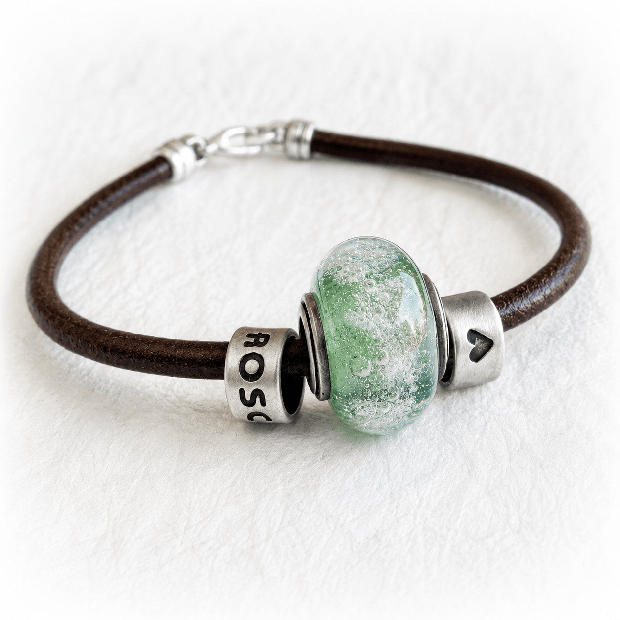 Memorial bracelet with a handmade green glass memorial bead sterling silver slider beads and a leather chord